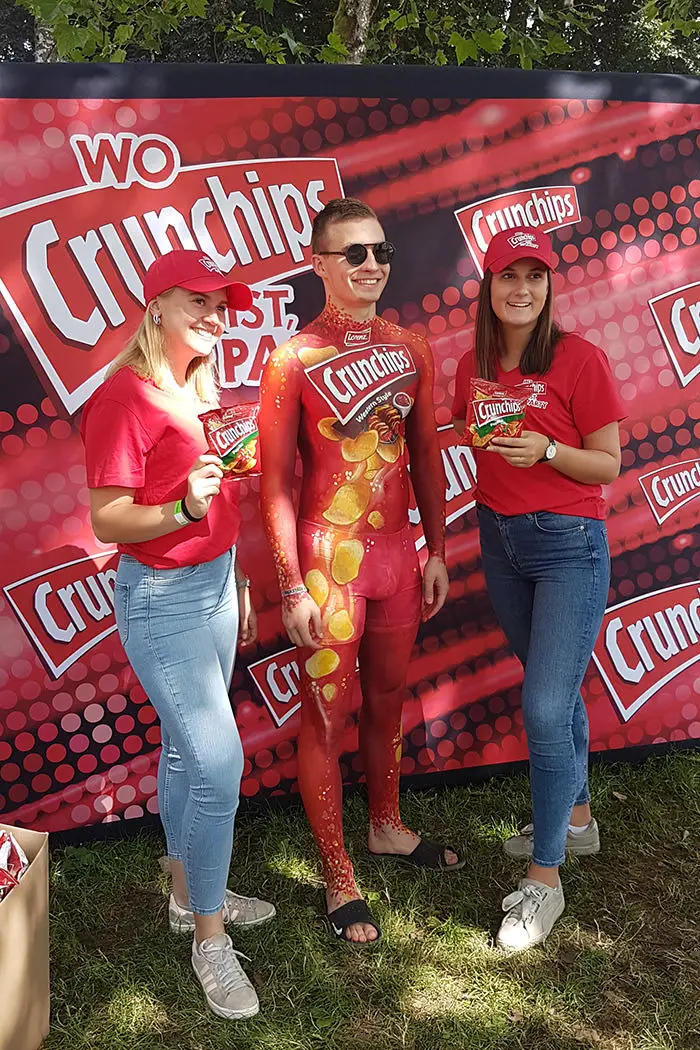 Commercial body painting by Riina Laine. Logo body art for Crunchips, PR event.